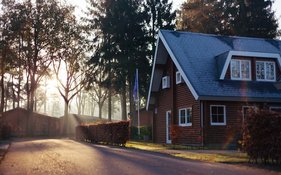 Brick house with a dark roof among tall trees